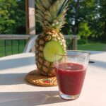 Glass of Zobo with a pineapple al fresco.