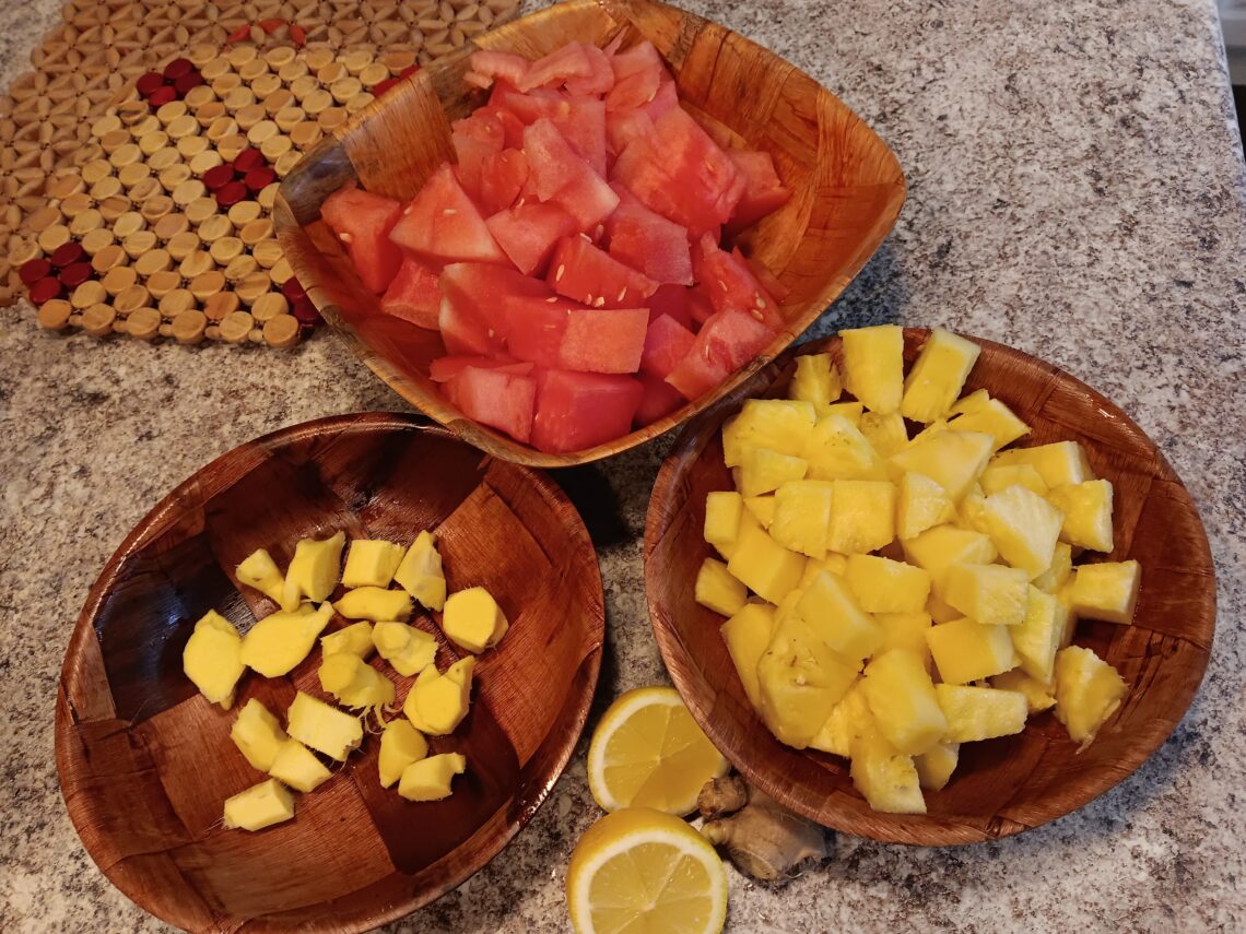 Chopped Watermelon, ginger, pineapple and lemon in bamboo bowls.