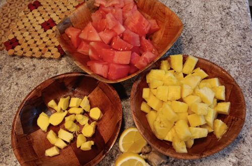 Chopped Watermelon, ginger, pineapple and lemon in bamboo bowls.
