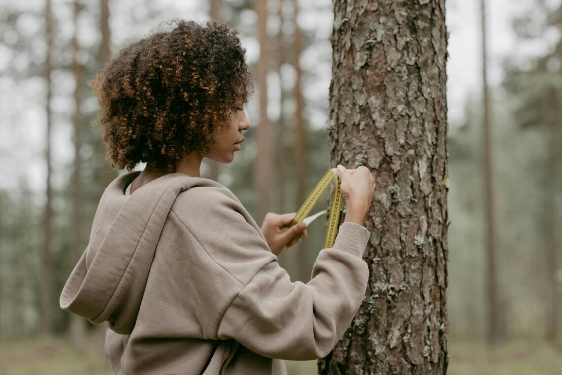 Woman measuring tree trunk. Citizen Scientist