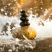 Stacked Pebbles splashed with water, bathed in natural light.